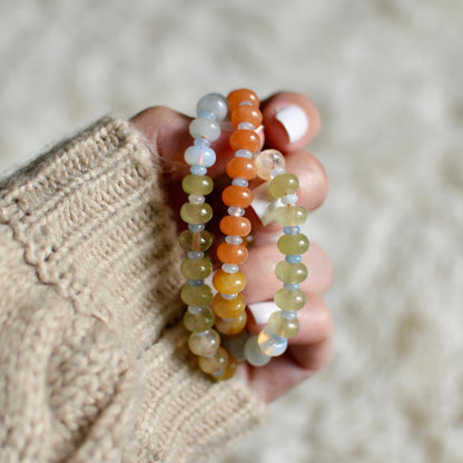 Hand holding two beaded necklace